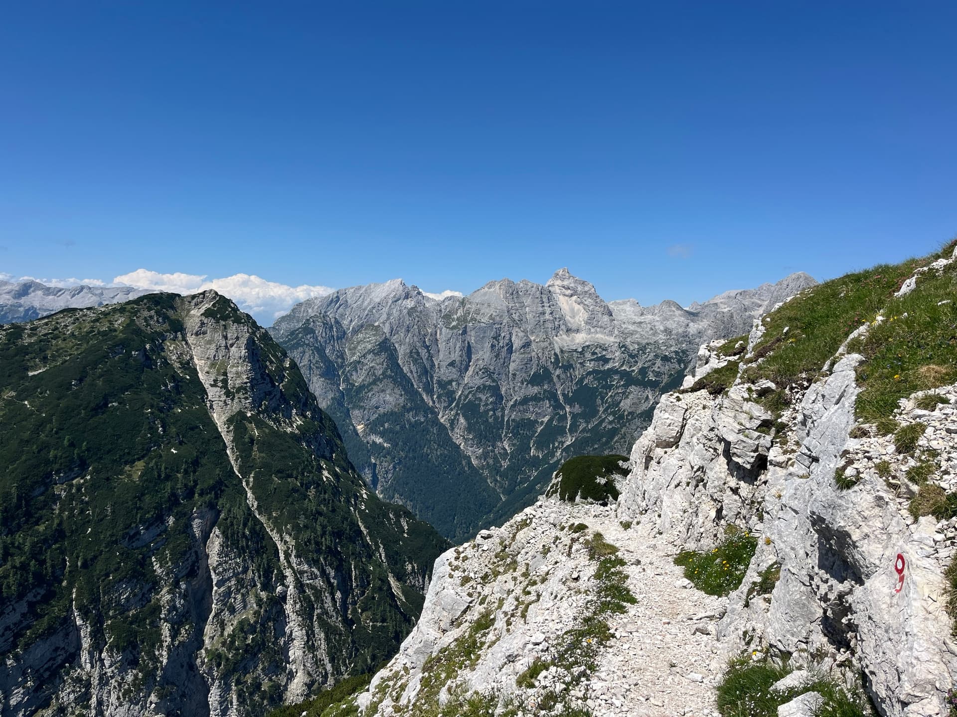 Julian Alps mountain panorama with rocky hiking trail and blue sky