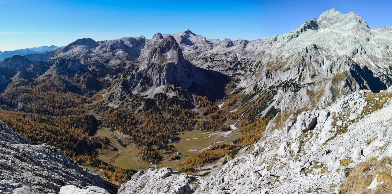 View of Velo Polje valley and rocky mountains from Vodnik hut in autumn.